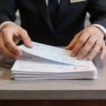 Main street bank teller handling returned checks